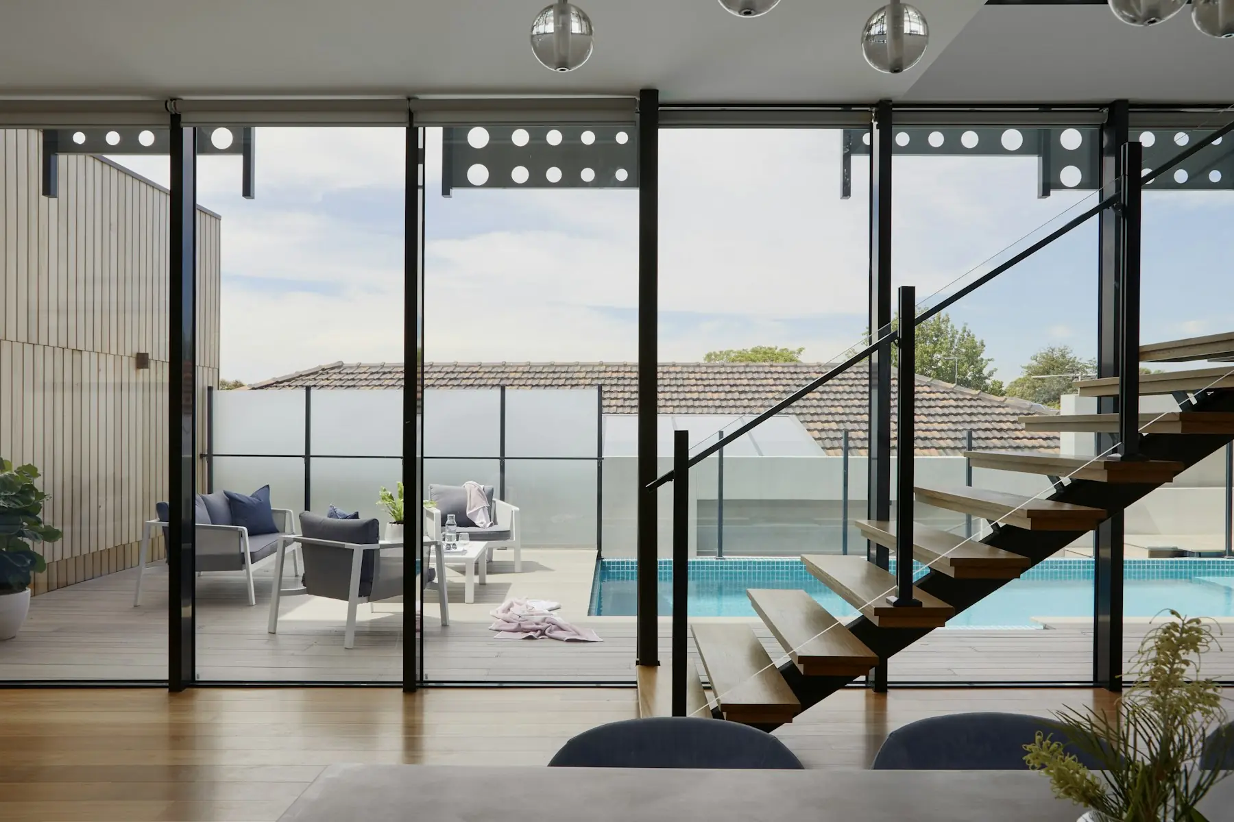 Glass-walled living room overlooking the water